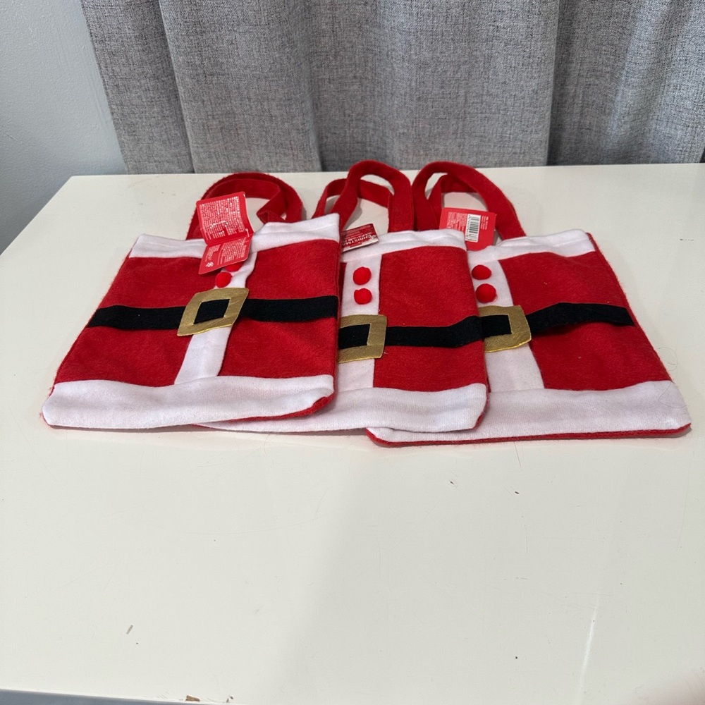 3 Christmas fabric Santa bags. NWT.